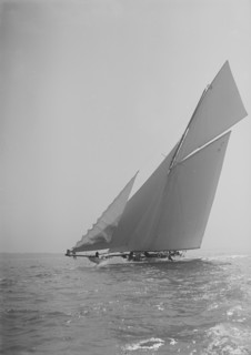 The 19-metre cutter 'Norada' sailing close-hauled, jib flapping, 1911. Creator: Kirk & Sons of Cowes.