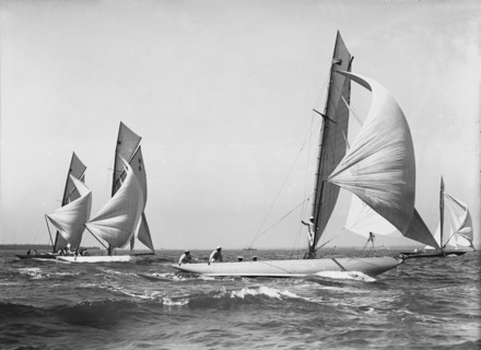 Group of 8 Metres sailing yachts racing downwind, 1911. Creator: Kirk & Sons of Cowes.