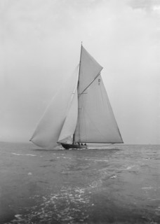 The majestic 15 Metre class 'Pamela' sailing with spinnaker, 1913. Creator: Kirk & Sons of Cowes.