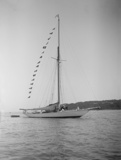 The 40-rater cutter 'Carina' at anchor with flags, 1911. Creator: Kirk & Sons of Cowes.