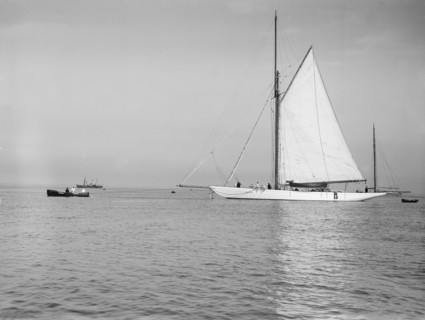 Sailing yacht 'Bona' being towed, 1912. Creator: Kirk & Sons of Cowes.