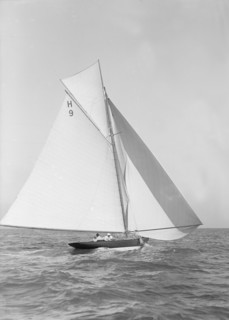The 8 Metre class 'Termagent' (H9) sailing with spinnaker, 1911. Creator: Kirk & Sons of Cowes.