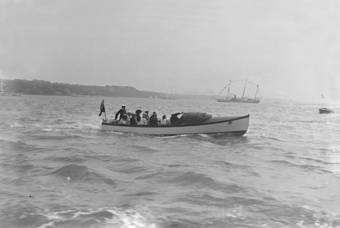 Modwena's motor launch with Modwena in the background, 1911. Creator: Kirk & Sons of Cowes.