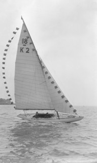 The 18-foot keelboat 'Prudence' (K2) with prize flags, 1922. Creator: Kirk & Sons of Cowes.