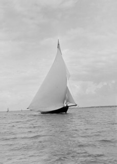 The yawl 'Harbinger' running downwind, 1922. Creator: Kirk & Sons of Cowes.