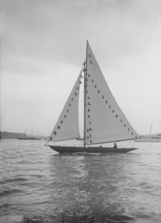 The 7 Metre sailing yacht 'Pinaster' (K8) with prize flags, 1912. Creator: Kirk & Sons of Cowes.