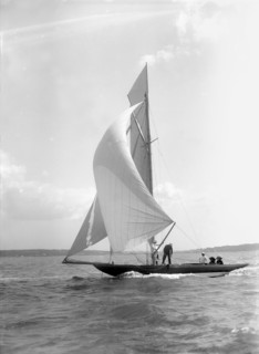 The 8 Metre 'Termagant' sailing with spinnaker, 1911. Creator: Kirk & Sons of Cowes.