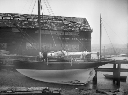The yawl 'Banzai' dried out at boatyard mooring, 1912. Creator: Kirk & Sons of Cowes.
