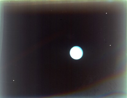 Uranus with satellites Miranda, Ariel and Umbriel, from Voyager 2, 24 January 1986. Creator: NASA.