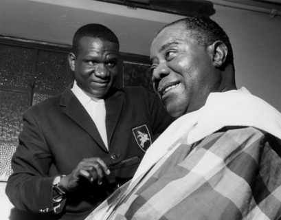 Louis Armstrong having haircut in Hammersmith, London, 1962.