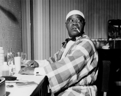 Louis Armstrong relaxing backstage, Finsbury Park Astoria, London, 1962.