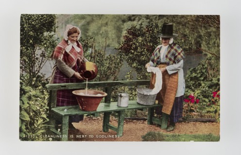 Cleanliness is next to Godliness.  Women in Welsh costume washing in tubs on bench, c1900s