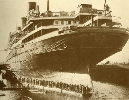 Cleaning the Hull of the "Majestic" in Dry Dock', c1930.
