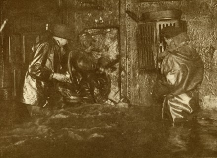 Divers Plugging A Leak During Salvage Operations Waist-Deep In Water On the Lower Decks Of The Germ