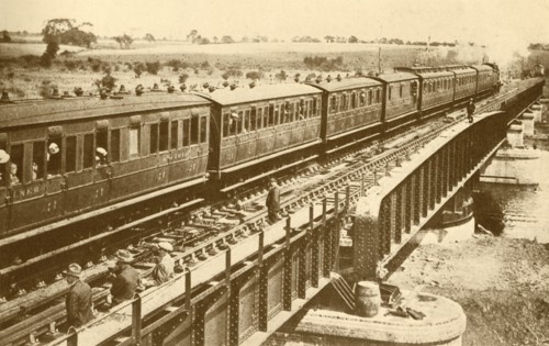 A Train Passing Over The Bridge', c1930.