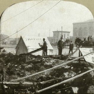 True grit - Barber painting sign on tent stretched on sidewalk of former place', 1906.
