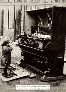 Child with damaged piano after an air raid made her homeless, First World War