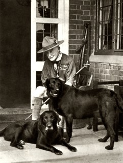 Robert Baden-Powell at home with his dogs, c1929