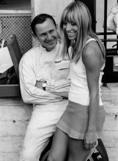 Bruce McLaren with female admirer in the pits, 1967 Italian Grand Prix. Creator: Unknown.