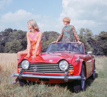1968 Triumph TR5 with female models, (copyright B.M.I.H.T.). Creator: Unknown.