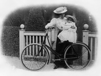 Beeston Humber cycle, Mrs. Hicks with child. Creator: Unknown.
