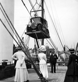 1910 Mercedes being craned onboard ship. Creator: Unknown.