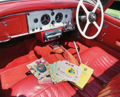 1960 Jaguar XK150 interior with record player and 7inch vinyl discs.. Creator: Unknown.