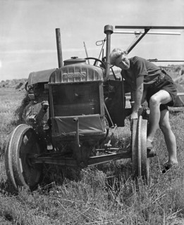 Fordson tractor, with Land girl 1940's. Creator: Unknown.
