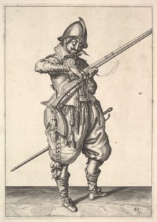 A soldier on guard shaping the match between his thumb and his forefinger, from the Marksmen s.... Creator: Unknown.