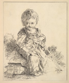 Un enfant assis sur une motte de terre