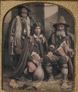 Three Men in Shepherd Attire, One with Bagpipes, the Other Two Holding Bread, 1850s.