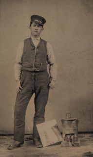 Tinsmith with Coal Heater and Sheet of Tin, 1870s-80s.