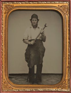 Man Gripping Sledgehammer, Wearing Leather Half Apron and Cap, 1850s-60s.