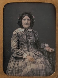 Seated Elderly Woman Wearing Plaid Dress and Bonnet, 1854-60.