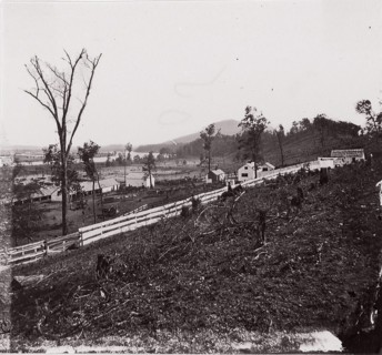 [White picket fence with buildings in background]. Brady album, p. 123, 1861-65. Formerly attributed to Mathew B. Brady.