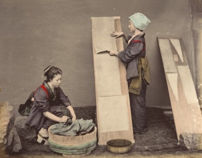 [Two Japanese Women Posing with Laundry], 1870s.
