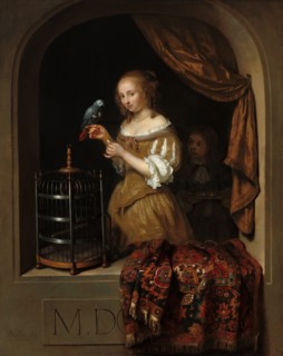 A Woman Feeding a Parrot, with a Page, 1666.
