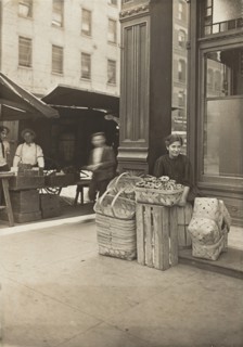 Lena Lochiavo - 11 years old, basket (and pretzel) seller, at Sixth Street Market in front of saloon entrance, Cincinnati, Ohio, 3136.