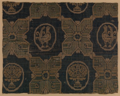 Textile Fragment, probably Iran, 8th-9th century. Four-pointed stars, in between  roundels bearing stylized florals and birds.