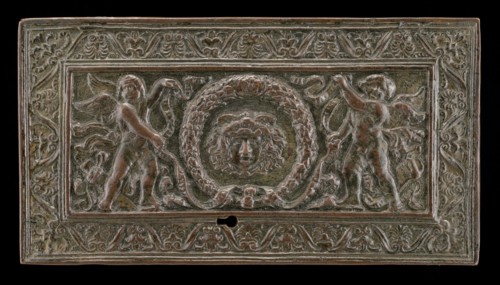 Cover of a writing casket: Geniuses with Wreath and Medusa Head, c. 1500.