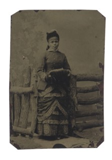 Tintype of woman in jacket and dress with hat and muff, 1880s. Creator: Unknown.