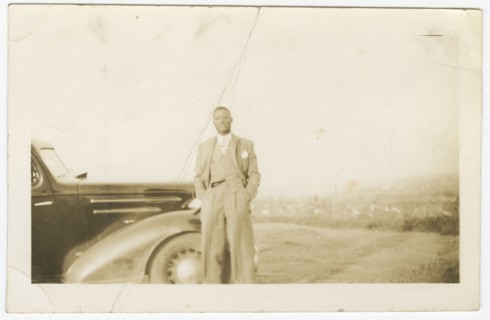 Photograph of an unidentified man in front of car, ca. 1920. Creator: Unknown.