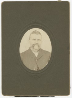 Photograph of a man with a mustache wearing a dark jacket, late 19th century. Creator: Unknown.