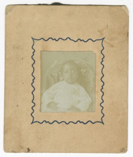 Photograph of a baby dressed in white and sitting in a chair, ca. 1870. Creator: Unknown.