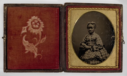 Tintype of a girl in a plaid dress, 1870s. Creator: Unknown.