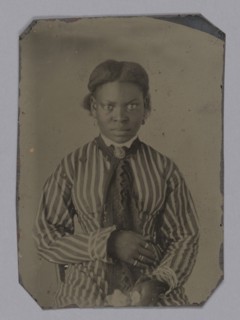 Tintype of young woman in striped dress, Late 1860s. Creator: Unknown.