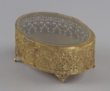 Gold metal scrollwork jewelry box from Mae's Millinery Shop, 1941-1994. Creator: Unknown.