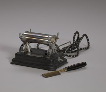 Electrical hot comb heater and hot comb, 1920s. Creator: Unknown.