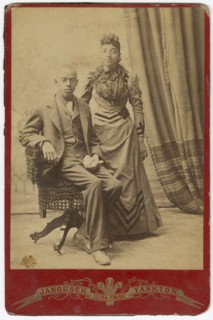 Photograph of African-American man and woman in formal clothes, late 19th century. Creator: Louis Janousek.