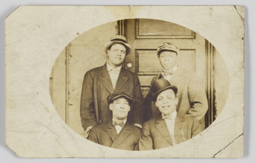 Photographic postcard of four unidentified men, 1906-1915. Creator: Unknown.